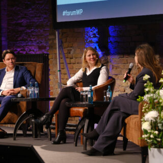 Moderatorin Tina Teucher auf der Bühne mit zwei Gästen des Forum Wärmepumpe 2025 in Berlin