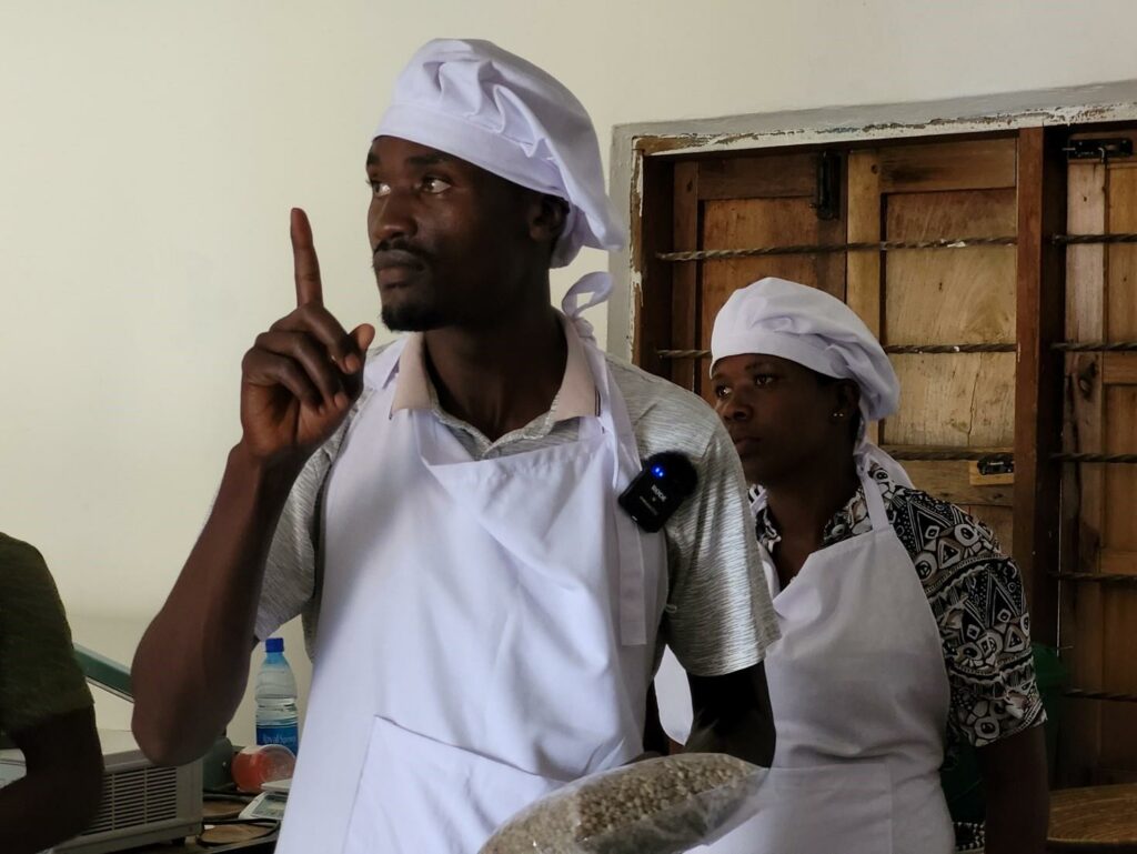 two people in work outfits at the KAFRED coffee production site